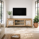 Lifestyle image of a whitewashed carved console table made of mango wood with floral motifs, four compartments; artisanal living room furniture, 180 × 40 × 65 cm.