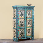 Side angle image of a Hand-painted reclaimed wood cabinet with floral motifs and green frame – Drisina by Om Home & Garden, a unique piece of sustainable furniture with bohemian flair.