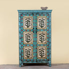 Image of a Hand-painted reclaimed wood cabinet with floral motifs and green frame – Drisina by Om Home & Garden, a unique piece of sustainable furniture with bohemian flair.