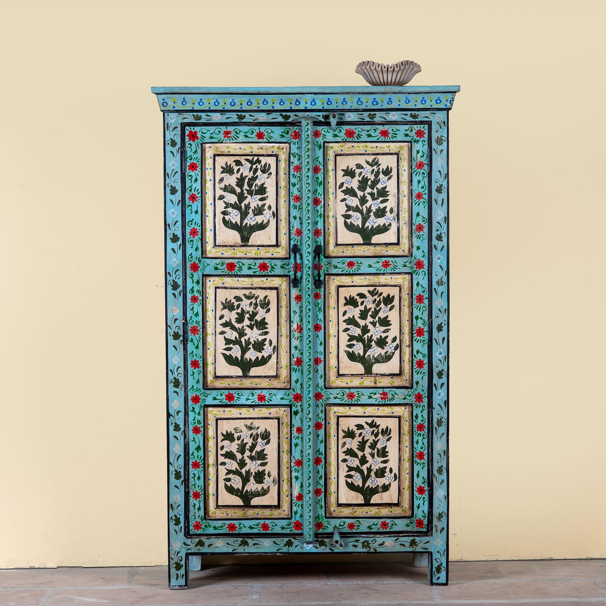 Image of a Hand-painted reclaimed wood cabinet with floral motifs and green frame – Drisina by Om Home & Garden, a unique piece of sustainable furniture with bohemian flair.