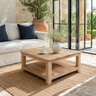 Lifestyle image of a Eklavya minimalist square mango wood coffee table with spacious lower shelf 100cm