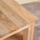 Close up image of a Eklavya minimalist square mango wood coffee table with spacious lower shelf 100cm