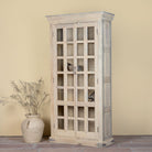 Side angle image of a reclaimed wood display cabinet Eknoor with glass-panelled doors and natural weathered finish. Sustainable living room furniture that can also function as a reclaimed wood wardrobe with spacious shelving.