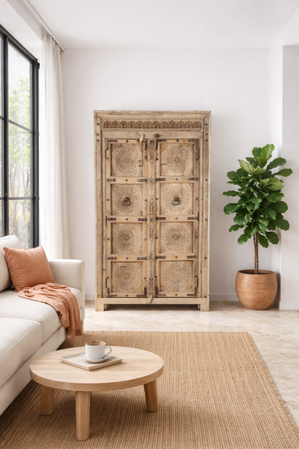 Lifestyle imagination of a reclaimed teak wood cabinet Elayna featuring an antique Indian door with carved motifs and iron accents. A unique piece of old door furniture in Mediterranean style, offering practical storage and historic charm.