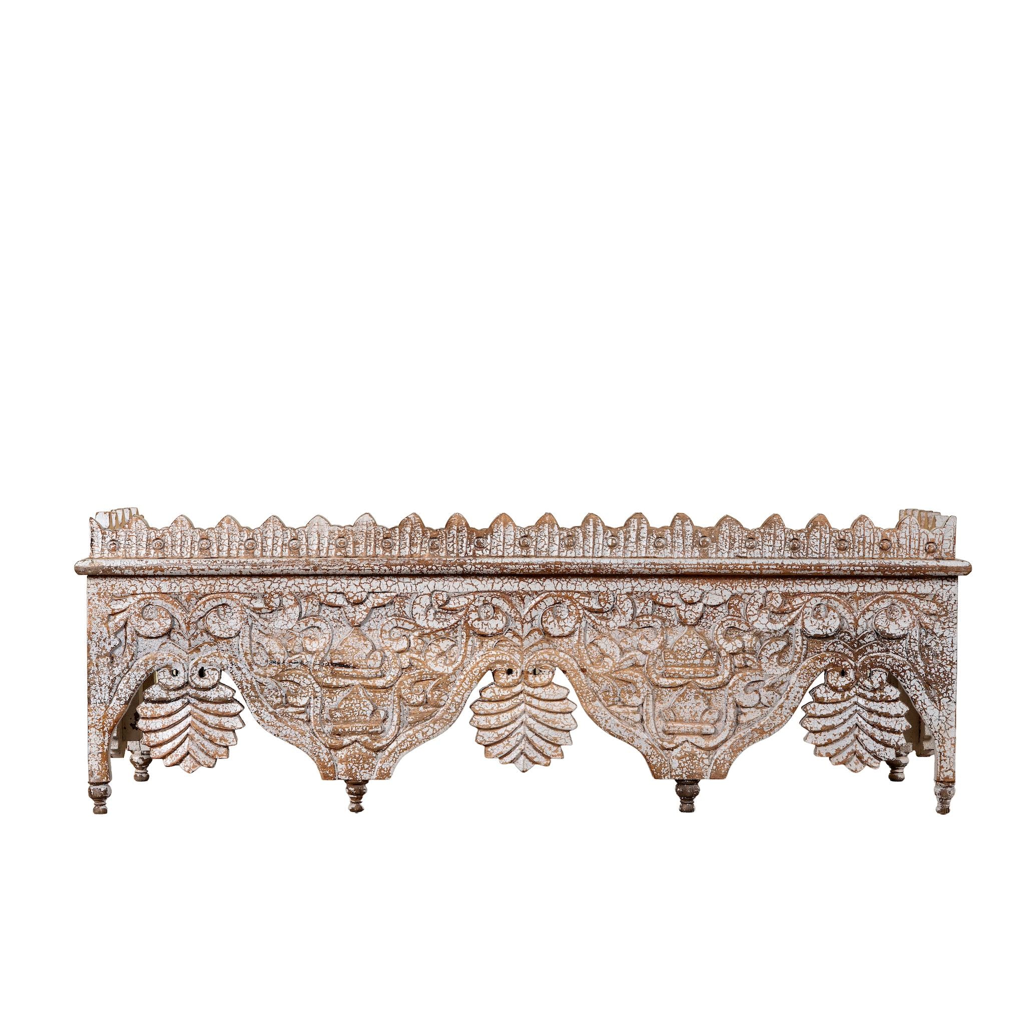White background image of a carved mango wood shelf in distressed vintage finish; artisanal furniture and vintage home decor, 90 × 25 × 30 cm.