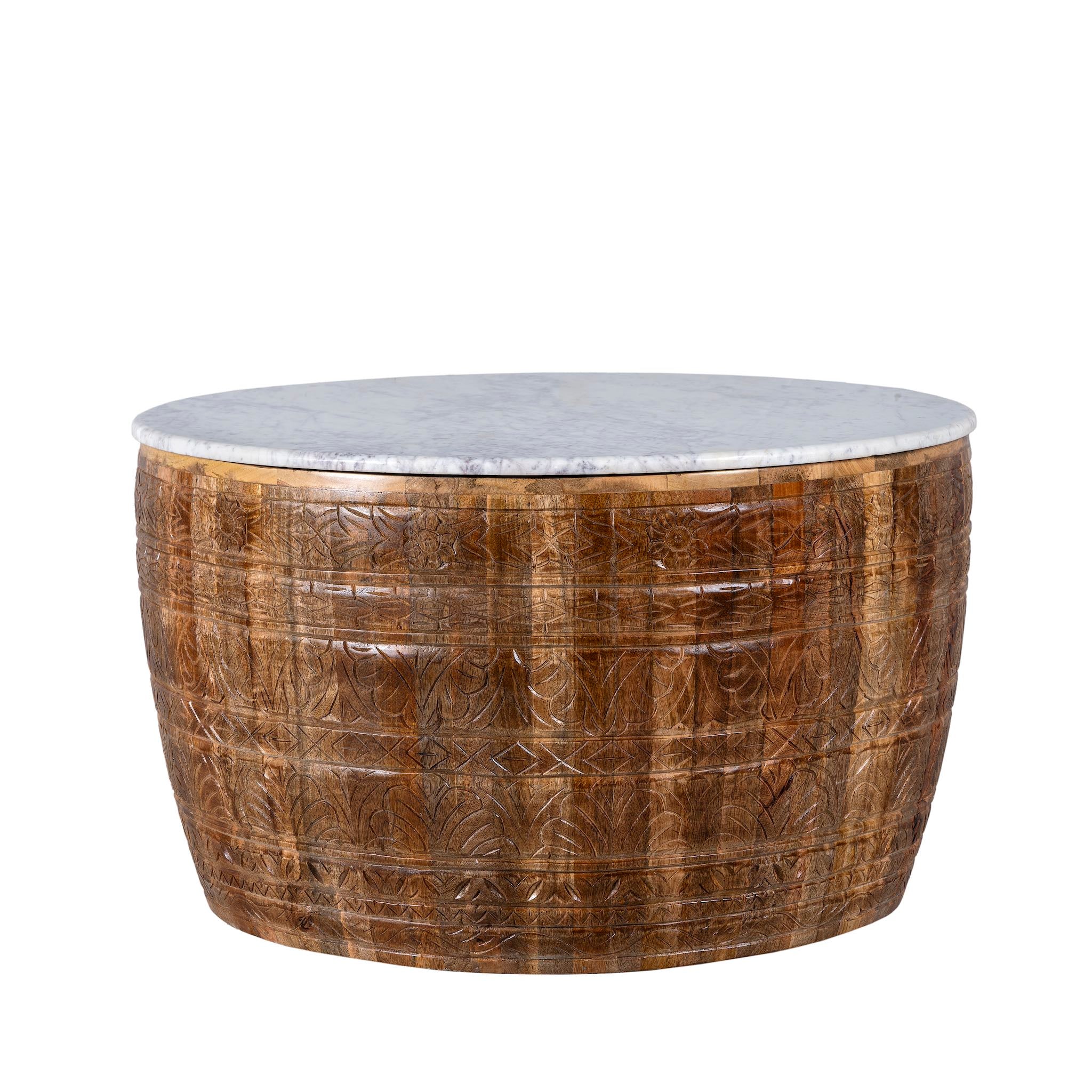 White background image of a round hand carved mango wood coffee table with a white marble top.