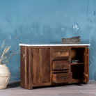 Open door image of a wabi sabi furniture driftwood sideboard with white marble top, minimalist Japandi cabinet with drawers and sliding surface, 125 × 35 × 75 cm.