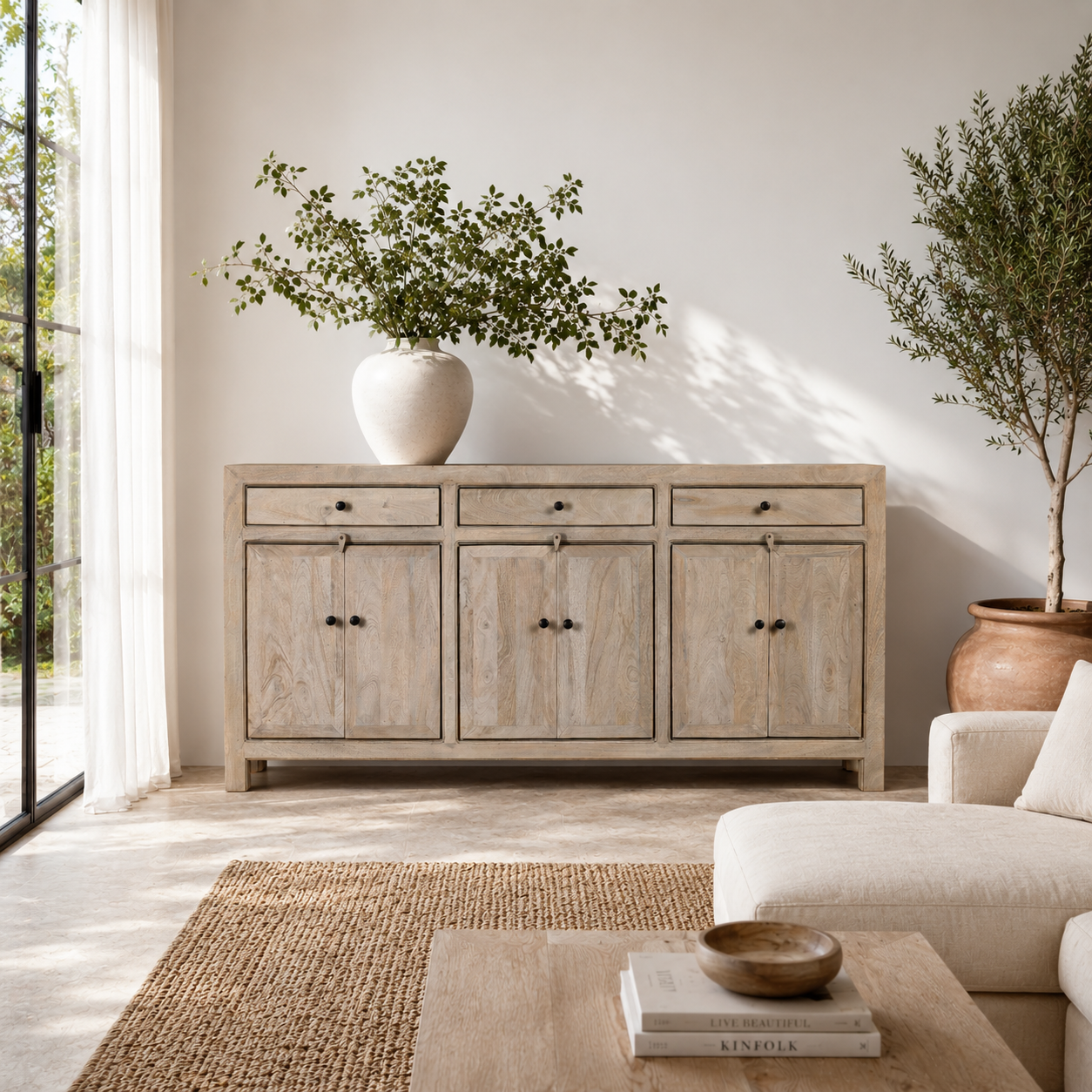 Lifestyle imagination of a sandblasted mango wood sideboard with 3 drawers and 4 cabinet doors; Mediterranean-inspired mango wood furniture, 180 × 40 × 90 cm.