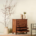 Side angle view with open drawers of a chest of drawers made from reclaimed teak wood, featuring a minimalist design with five spacious drawers and a warm natural finish- ideal for rustic and modern interiors.