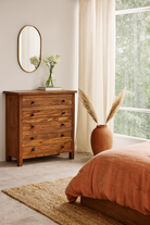 Lifestyle imagination of a chest of drawers made from reclaimed teak wood, featuring a minimalist design with five spacious drawers and a warm natural finish — ideal for rustic and modern interiors.