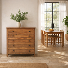 Lifestyle image of a chest of drawers made from reclaimed teak wood, featuring a minimalist design with five spacious drawers and a warm natural finish — ideal for rustic and modern interiors.