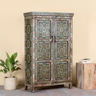 Side angle image of a reclaimed wood cabinet with floral and geometric designs, perfect for a bohemian interior with Mediterranean style.