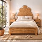 Lifestyle image of a mango wood bed frame with a hand carved headboard in Farn design.
