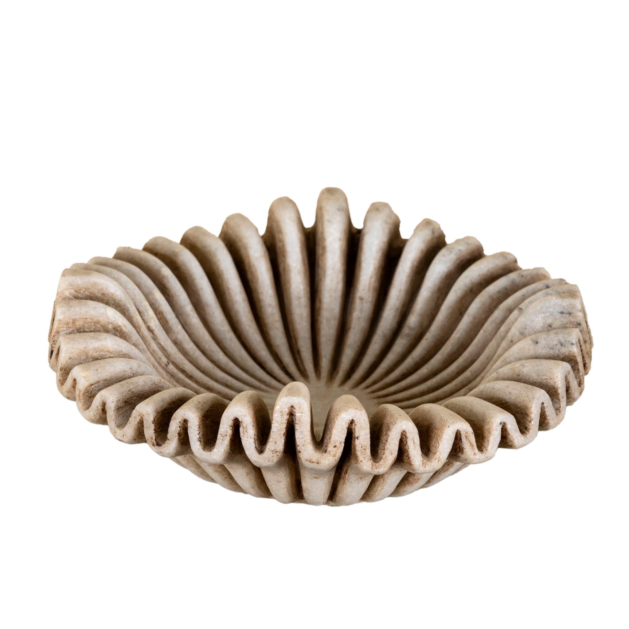 White background image of a Hand-carved folded beige marble bowl with wave-shaped rim and radial design, ideal for vintage home decoration and Indian home decor.