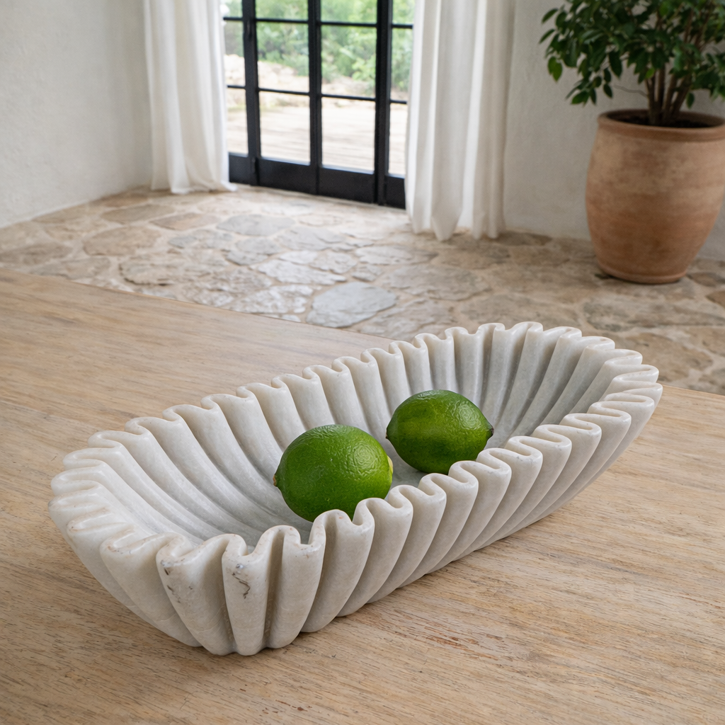 Lifestyle imagination of a elongated hand-carved white marble bowl with folded pleated edges – Indian decorative marble accessory.