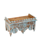 Side angle image of a turquoise distressed mango wood shelf with ornate carvings; artisanal furniture and vintage home decor, 60 × 32 × 32 cm.