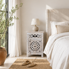 Lifestyle scene with a whitewashed nightstand made of mango wood with Mediterranean-style carved detailing and one drawer – Gagan bedside table by Om Home & Garden