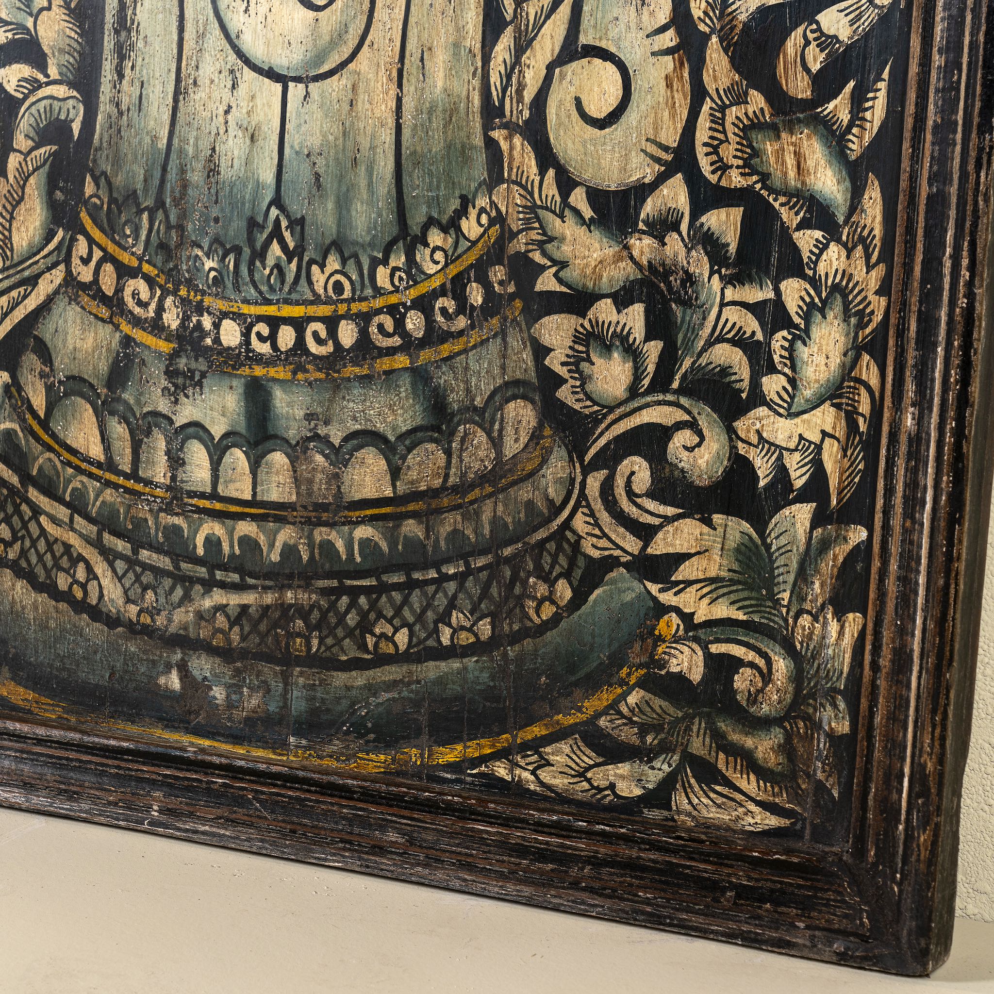 Close up image of a hand-painted wall panel made from old teak wood, featuring an intricate depiction of Lord Ganesh in vibrant earthy tones, surrounded by ornate floral patterns, showcasing traditional Indian artistry and spiritual symbolism.
