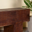 Close up image of a Rustic wood bench made of reclaimed wood, full block design, sustainable furniture for hallways, living rooms, or terraces, 120 × 30 × 40 cm.