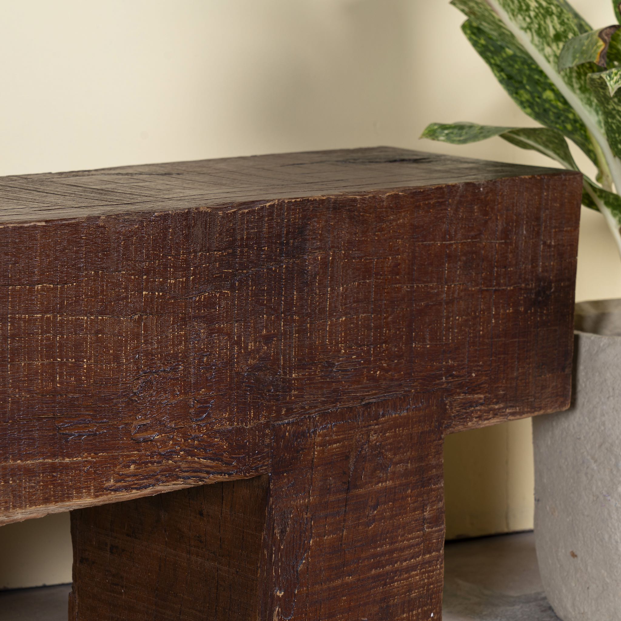 Close up image of a Rustic wood bench made of reclaimed wood, full block design, sustainable furniture for hallways, living rooms, or terraces, 120 × 30 × 40 cm.