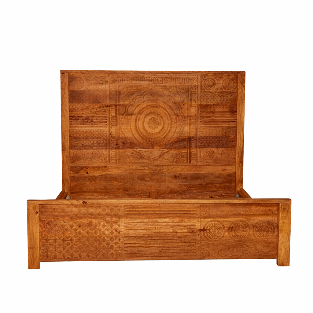 White background image of a hand carved mango wood bed frame in warm colours.