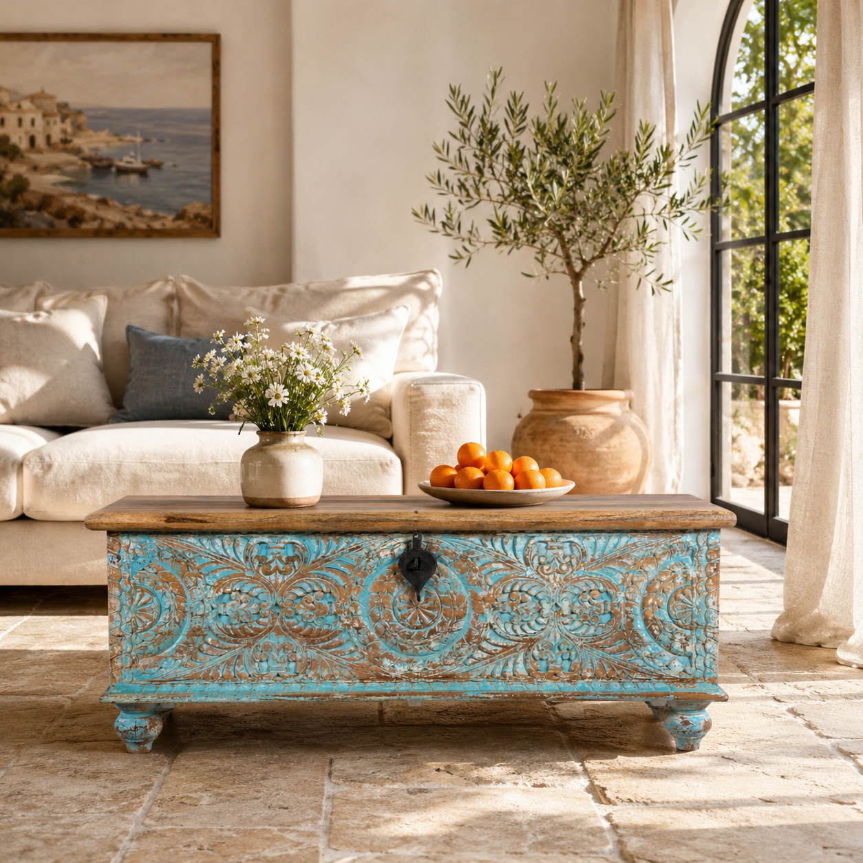 Lifestyle image of a hand-carved mango wood chest in blue with natural wood top – carved wooden furniture and wooden storage chest for eclectic or boho interiors.