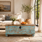 Lifestyle image of a hand-carved mango wood chest in blue with natural wood top – carved wooden furniture and wooden storage chest for eclectic or boho interiors.