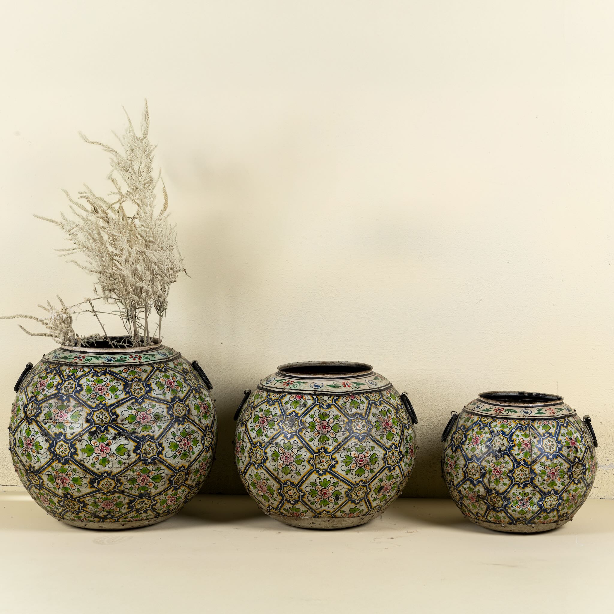 Set of 3 round hand-painted iron pots with silver floral designs on blue background, artisanal Indian home accessories and vintage decor accents.