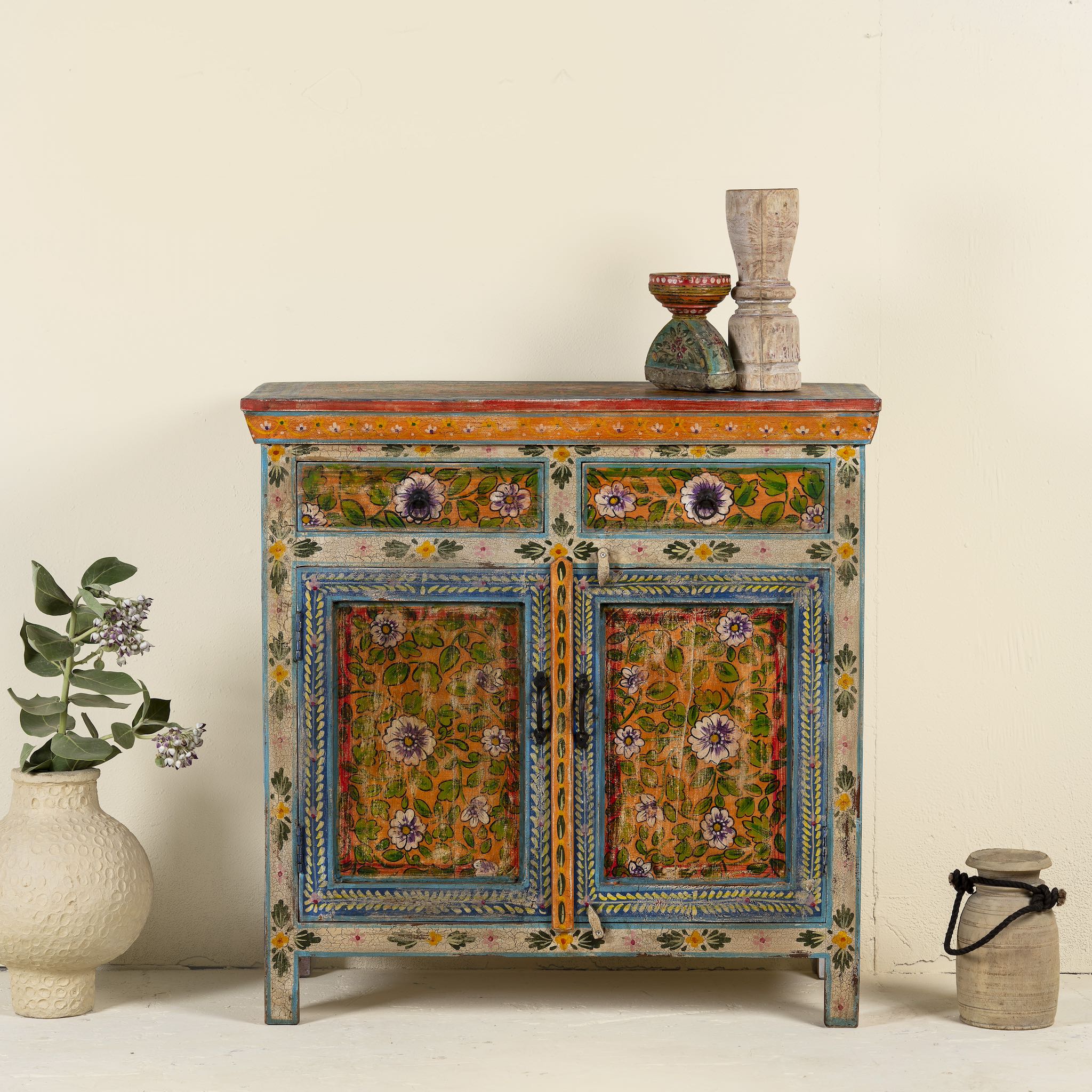 Image of a hand painted cabinet made of reclaimed wood with ornate floral design in vintage style.