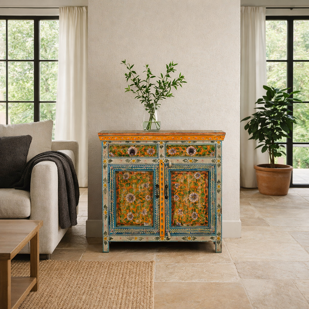 Lifestyle image of a hand painted cabinet made of reclaimed wood with ornate floral design in vintage style.