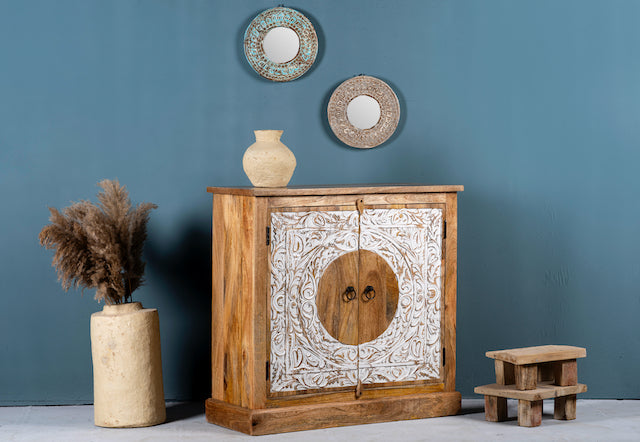 Side angle image of a carved wood furniture cabinet made from mango wood with floral whitewashed doors, 90 × 40 × 90 cm.