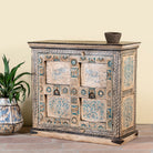 Side angle image of a hand-painted cupboard made from reclaimed wood and old Indian doors – a sustainable furniture piece perfect for Indian home decor and rustic interiors.