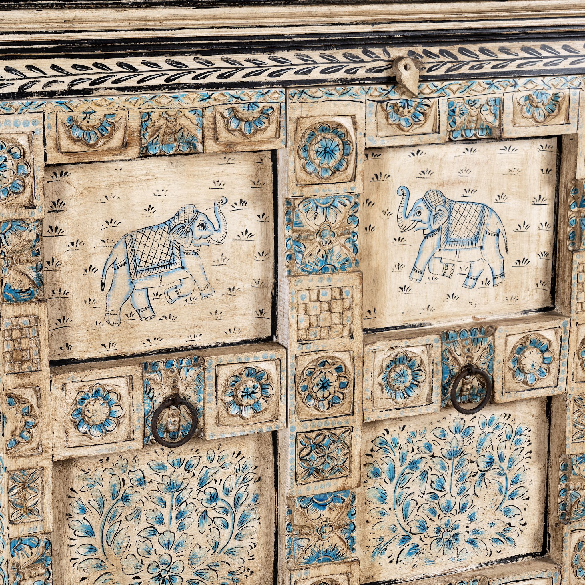 Close up image of a hand-painted cupboard made from reclaimed wood and old Indian doors – a sustainable furniture piece perfect for Indian home decor and rustic interiors.