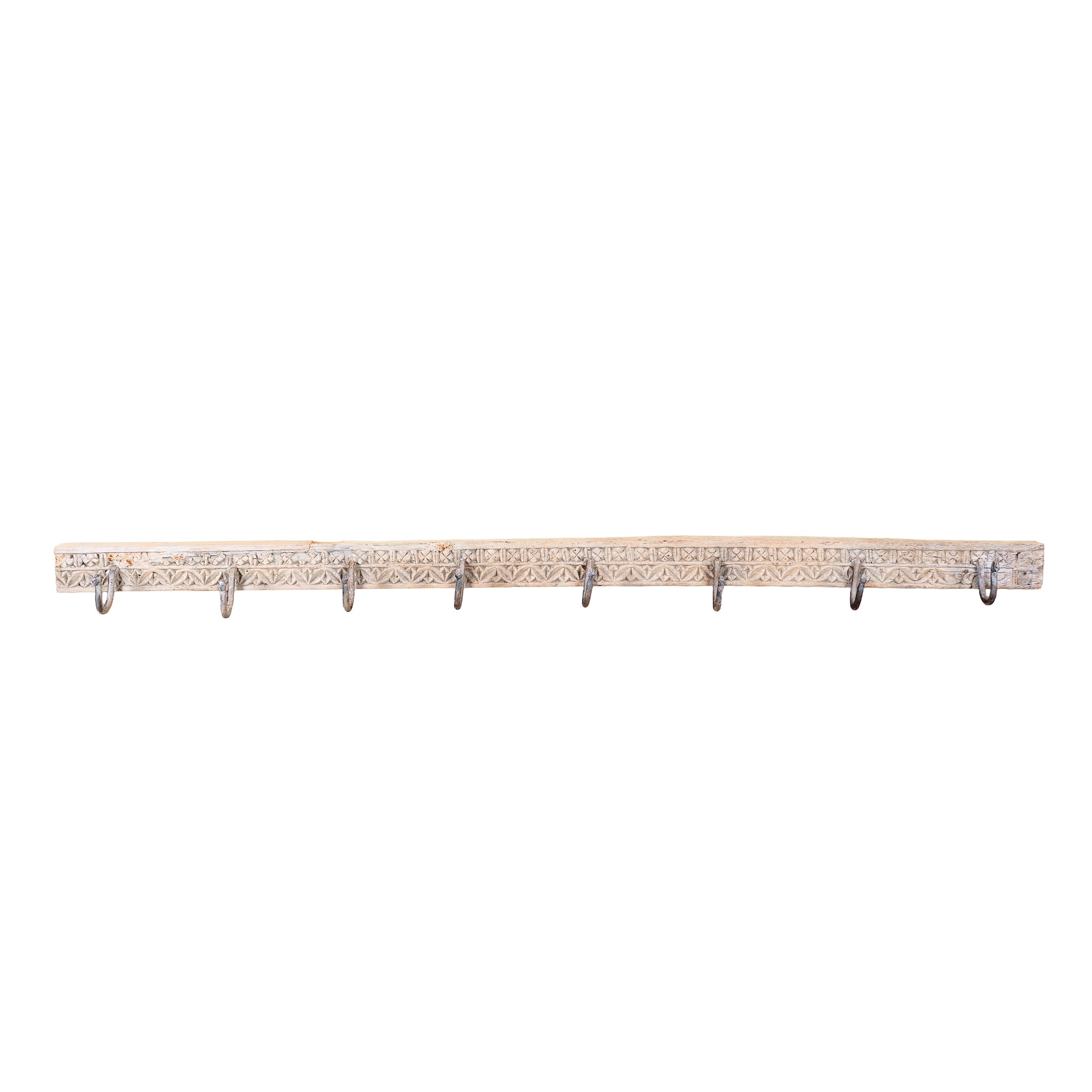 White background image of a Maharaja Hook Rack handcrafted from an antique Indian reclaimed wood architectural element with hand-carved floral details, bleached finish and eight iron hooks, 150x7x5cm.