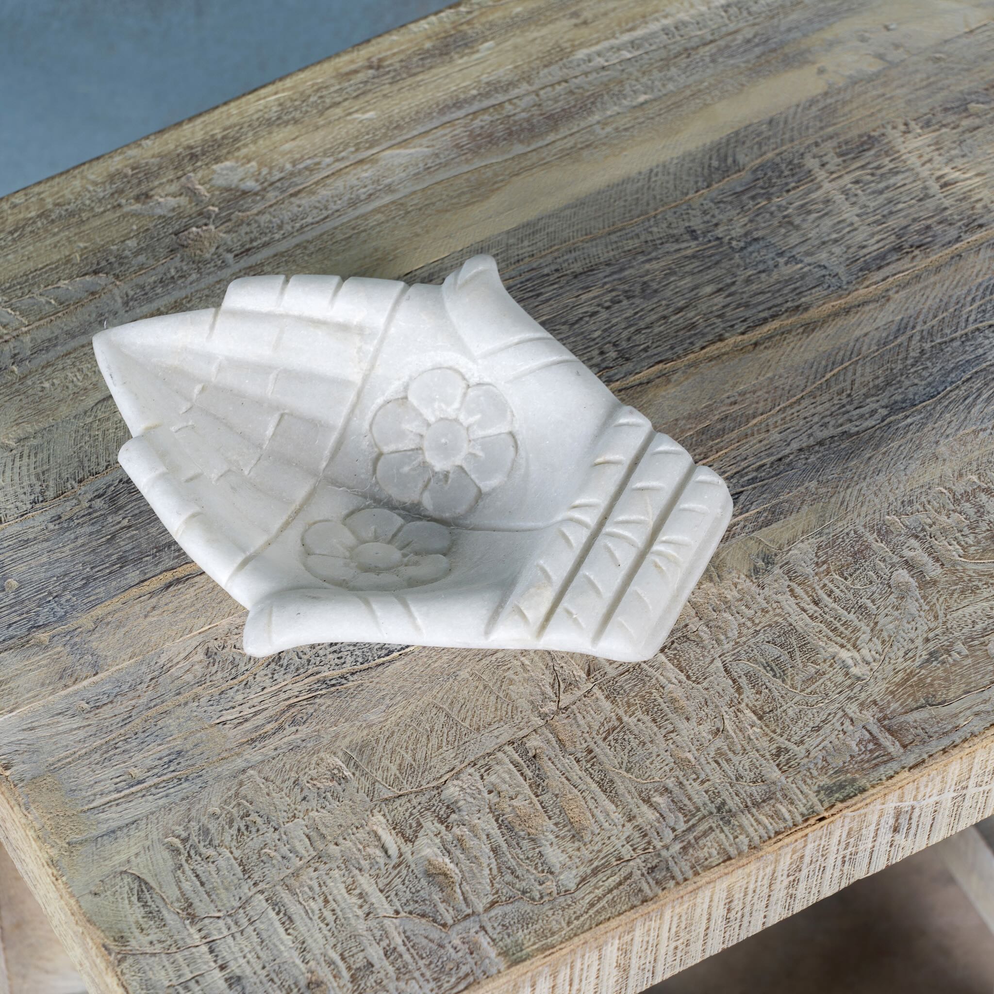White marble decorative bowl shaped like cupped hands with floral carving – hand-carved Indian marble accessory.