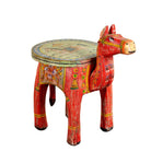 White background image of a hand-painted wooden horse-shaped side table with floral and folk motifs, a colourful and unique vintage home accessory from India.