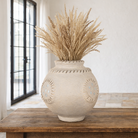 Lifestyle image of a handmade papier-mâché vase Peda with mirror-inlaid medallions and textured rim. A vintage home accessory and unique Indian decoration, perfect for dried flowers or as a sculptural accent in vintage home decor.