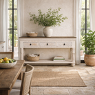 Lifestyle image of a carved mango wood console table with floral ornamentation; rich, exotic mango wood furniture, 150 × 90 × 45 cm.