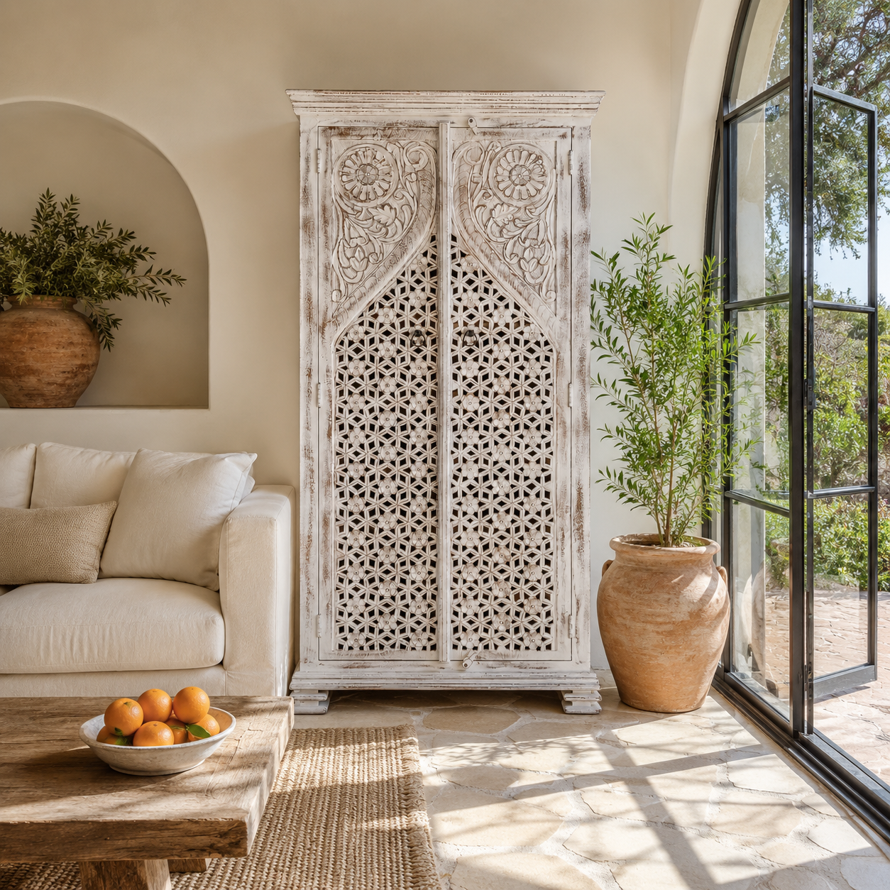 Lifestyle image of a white-washed hand-carved wooden wardrobe made of solid mango wood, vintage furniture with Mediterranean Ibiza style, 180 × 90 × 40 cm.