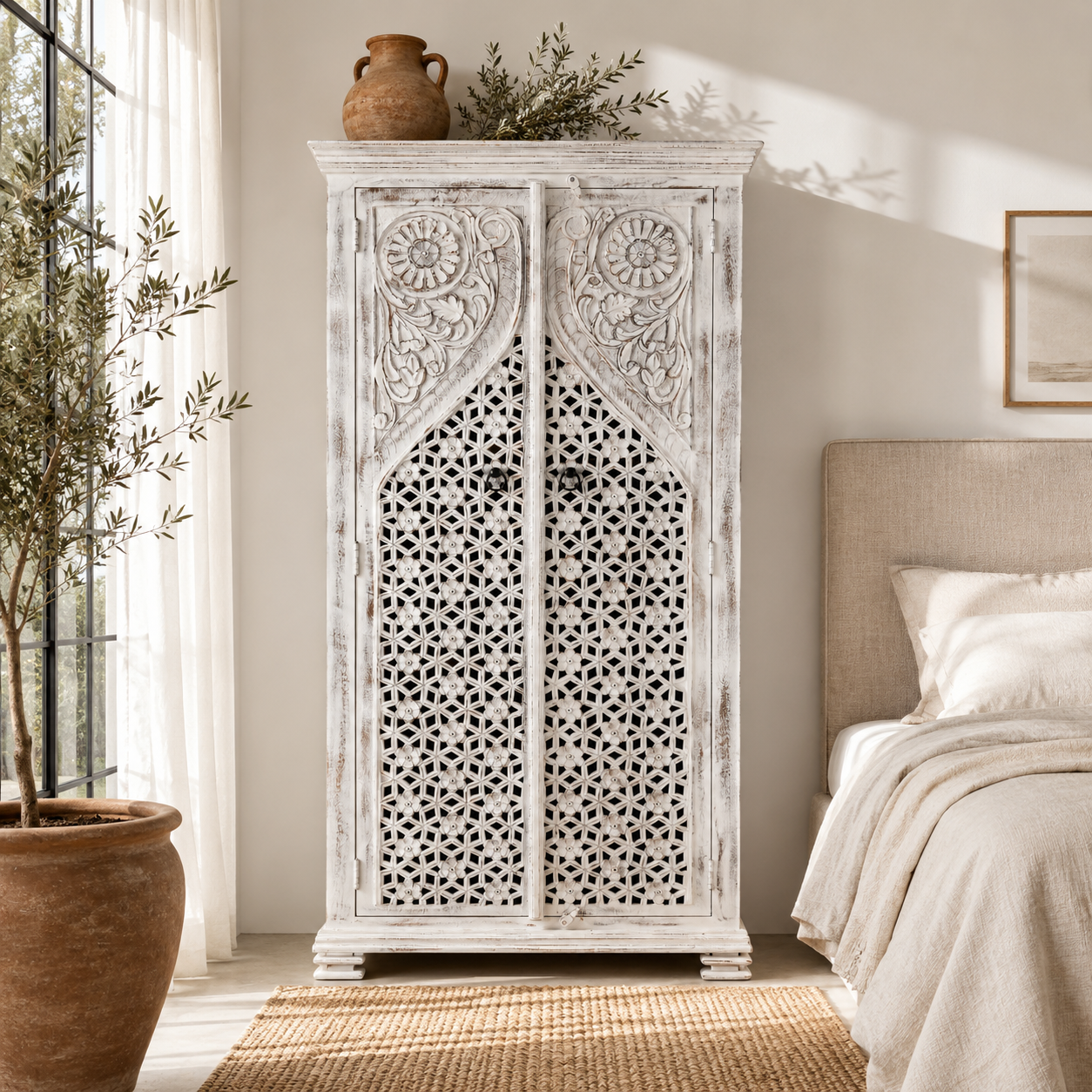 Lifestyle image of a white-washed hand-carved wooden wardrobe made of solid mango wood, vintage furniture with Mediterranean Ibiza style, 180 × 90 × 40 cm.