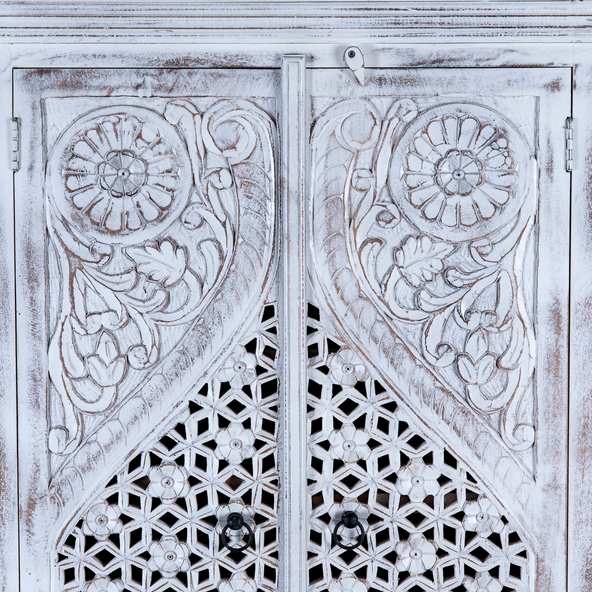 Closed up image of a white-washed hand-carved wooden wardrobe made of solid mango wood, vintage furniture with Mediterranean Ibiza style, 180 × 90 × 40 cm.