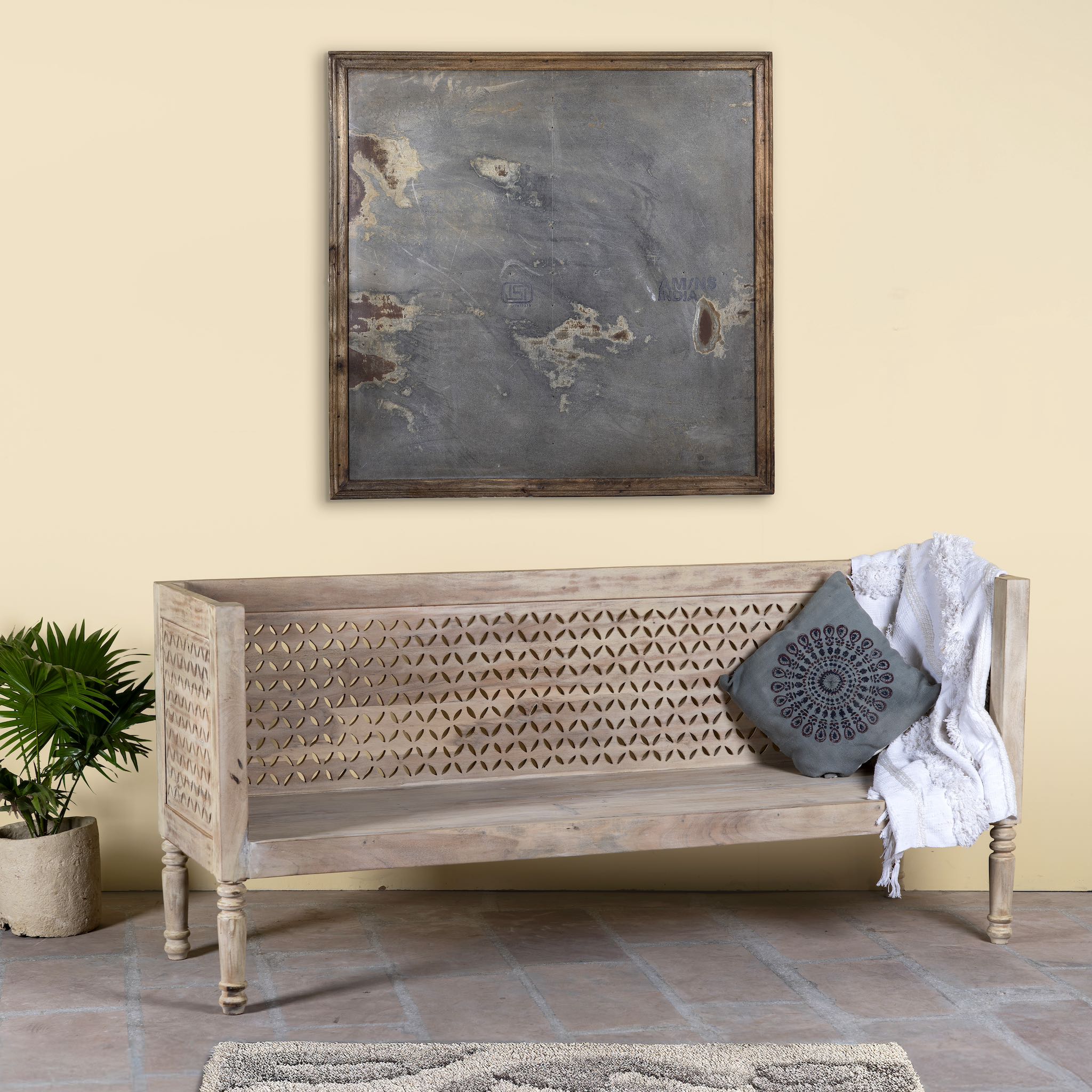 Side angle image of a hand-carved reclaimed wood bench with geometric backrest design, sandblasted Ibiza style finish, ideal for boho chic living room interiors, 176×56×95 cm.