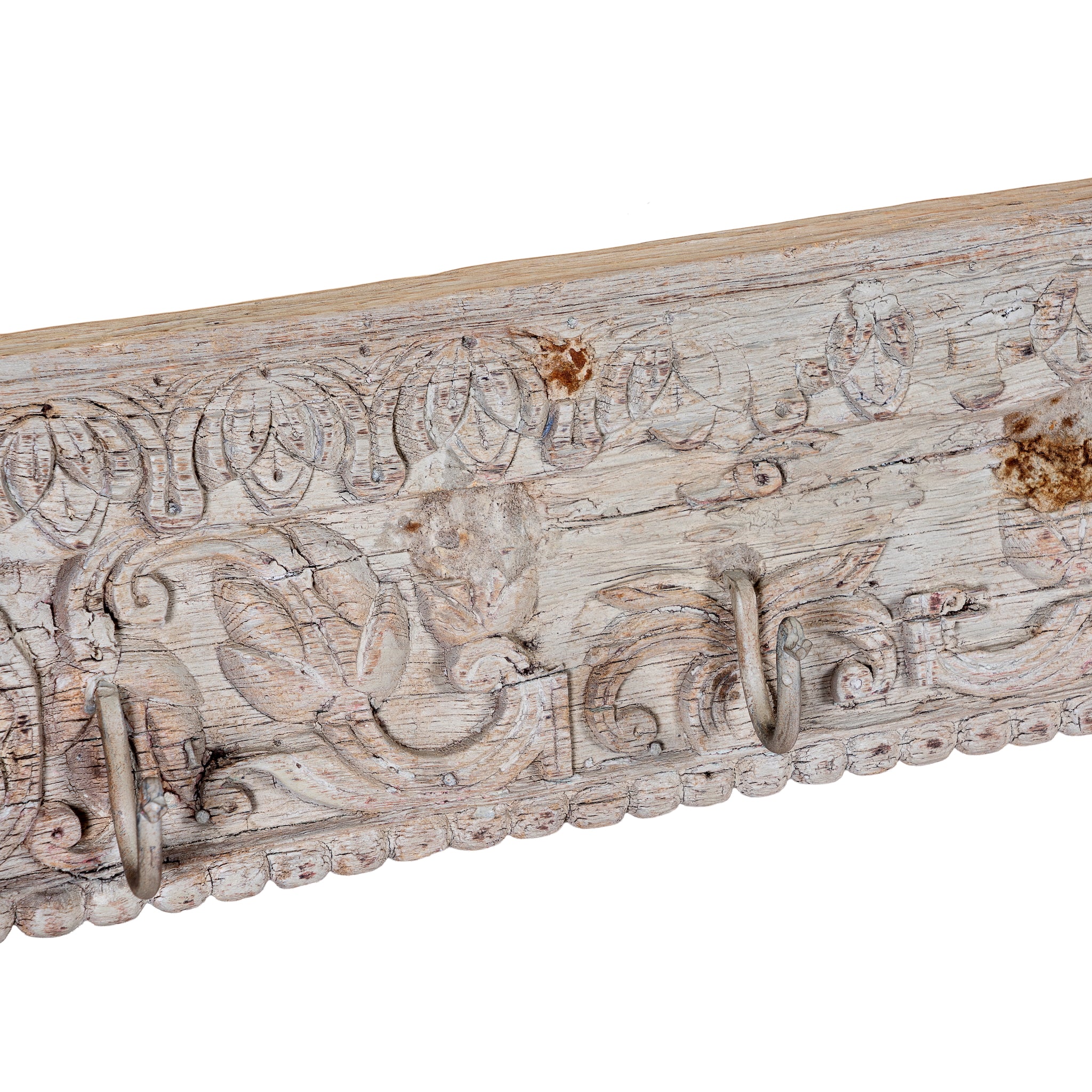 Close up image of a Heritage Hook Rack handcrafted from an antique Indian reclaimed wood architectural element with hand-carved floral details, bleached finish and seven iron hooks, 155x10x5cm.