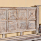 Close up image of a wooden bed frame with panelled headboard and footboard, made of reclaimed wood in sandblasted Ibiza style, boho beds and bedroom furniture, 180 × 200 × 140 cm.