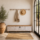 Lifestyle image of a Maharaja Hook Rack handcrafted from an antique Indian reclaimed wood architectural element with hand-carved floral details, bleached finish and eight iron hooks, 150x7x5cm.