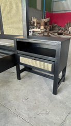 Side angle image of a mango wood night stand with rattan inserts; artisanal rattan furniture, 60 × 35 × 60 cm.