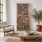 Lifestyle image of a hand-carved mango wood cabinet with floral motifs and silver finish – bedroom furniture with rustic charm and artisanal detail.