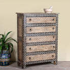 Side angle image of a hand painted beige-black wooden chest of 5 drawers in vintage style.
