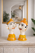 Lifestyle imagination of a of a set of 2 hand-painted Rajasthani papier maché heads featuring a man and woman in traditional attire, ideal for vintage home decoration and Indian home decor.