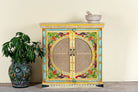 White background image of a hand-painted, hand-carved cupboard made of mango wood with floral design and rattan inserts.